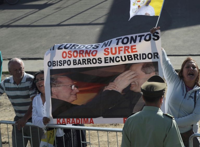 Protesters demonstrate against the Rev. Fernando Karadima, and his protege Juan Barros, bishop of Osorno, as Pope Francis rides past on his way to celebrates Mass at the Maquehue Airport in Temuco, Chile, Wednesday, Jan. 17, 2018. Chile's church has yet to recover its credibility following the scandal over Karadima, Chile's most notorious pedophile priest. (AP Photo/Alessandra Tarantino)