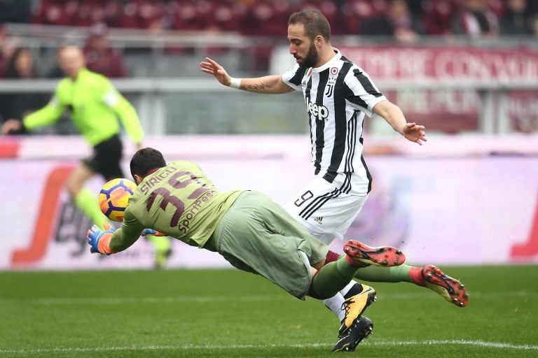 Torino's goalkeeper Salvatore Sirigu from Italy (L) fights for the ball with Juventus' forward Gonzalo Higuain from Argentina during the Italian Serie A football match between Torino and Juventus at Stadio Grande Torino in Turin on February 18, 2018. / AFP PHOTO / MARCO BERTORELLO