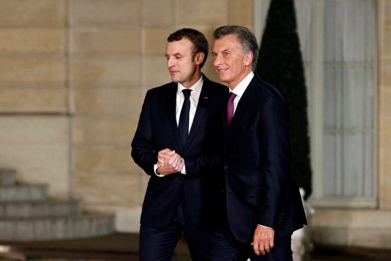 France President Emmanuel Macron, left, welcomes President of Argentina Mauricio Macri prior to a meeting, at the Elysee Palace, in Paris, Friday, Jan. 26, 2018. (AP Photo/Thibault Camus)