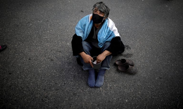 Un hombre en situación de calle pide plata en Buenos Aires (AP Photo/Natacha Pisarenko)