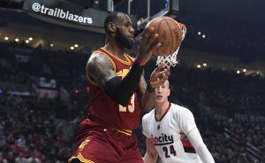 Cleveland Cavaliers forward LeBron James passes the ball as Portland Trail Blazers center Mason Plumlee defends during the first half of an NBA basketball game in Portland, Ore., Wednesday, Jan. 11, 2017. (AP Photo/Steve Dykes)