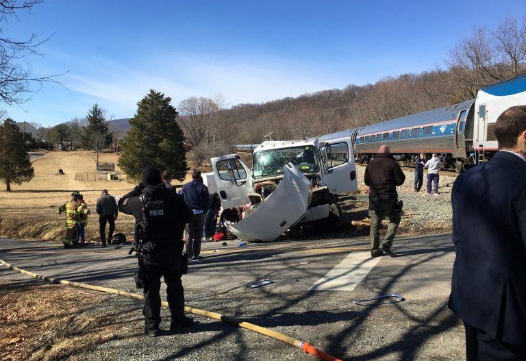 This photo provided by Rep. Bruce Poliquin, R-Maine shows emergency personnel standing near a chartered train carrying members of Congress after it hit a garbage truck in Crozet, Va., Wednesday, Jan. 31, 2018.  No lawmakers were believed injured.