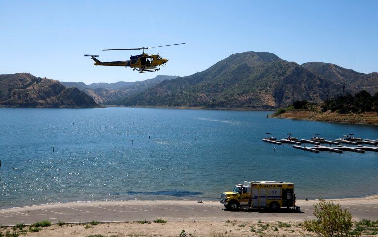 CORRECTS LAKE NAME TO PIRU - Members of the Ventura County Sheriff's Office search for former "Glee" actress Naya Rivera, Thursday, July 9, 2020 in Lake Piru, Calif. Rivera rented a boat on Wednesday and her 4-year-old son was found alone on the rented boat. (AP Photo/Ringo H.W. Chiu)