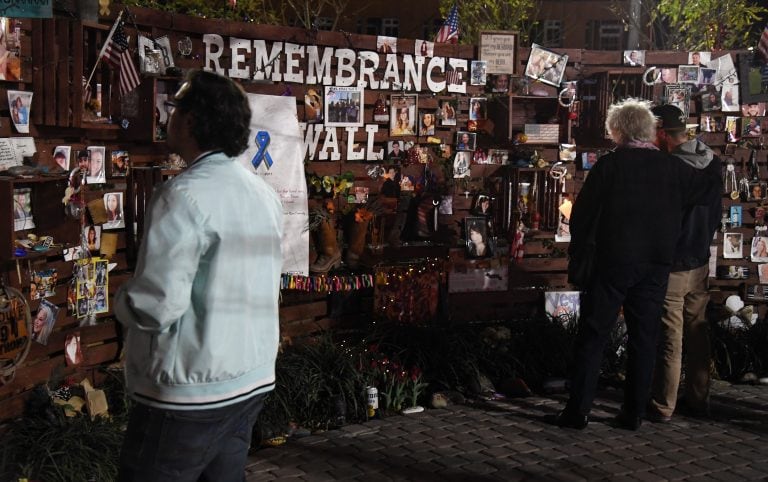 LAS VEGAS, NV - FEBRUARY 16: Attendees look at a remembrance wall during a candlelight vigil put together by the Route 91 Foundation at the Las Vegas Community Healing Garden for victims of Wednesday's shooting at Marjory Stoneman Douglas High School in Parkland, Florida on February 16, 2018 in Las Vegas, Nevada. The healing garden was created in the wake of the mass shooting on the Las Vegas Strip in October 2017. Nikolas Cruz, a former student at the Florida high school, has been arrested and charged with 17 murders in the February 14 shooting.   Ethan Miller/Getty Images/AFP
== FOR NEWSPAPERS, INTERNET, TELCOS & TELEVISION USE ONLY ==