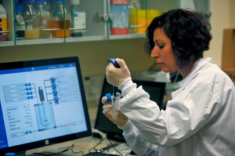 An Israeli scientist works at a laboratory at the MIGAL Research Institute in Kiryat Shmona in the upper Galilee in northern Israel on February 27, 2020. - After 4 years of multi-disciplinary research funded by Israel’s Ministry of Science and Technology in cooperation with Israel’s Ministry of Agriculture, MIGAL has achieved a scientific breakthrough that will lead to the rapid creation of a vaccine against Coronavirus. This possibility was identified as a by-product of MIGAL’s development of a vaccine against IBV (Infectious Bronchitis Virus), a disease affecting poultry, whose effectiveness has been proven in pre-clinical trials carried out at the Veterinary Institute. MIGAL has now made required genetic adjustments to adapt the vaccine to COVID-19, the human strain of Coronavirus, and is working to achieve the safety approvals that will enable in-vivo testing, enable the initiation of production of a vaccine to counter the Coronavirus epidemic currently spreading throughout the wor