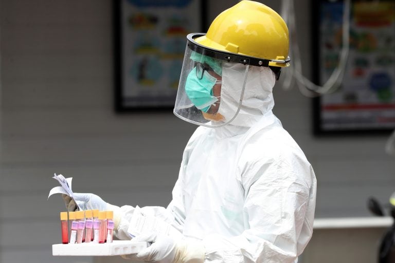 A health worker carries blood samples during a rapid test for the new coronavirus at a hospital in Jakarta, Indonesia, Tuesday, April 28, 2020. The new coronavirus causes mild or moderate symptoms for most people, but for some, especially older adults and people with existing health problems, it can cause more severe illness or death. (AP Photo/Achmad Ibrahim)