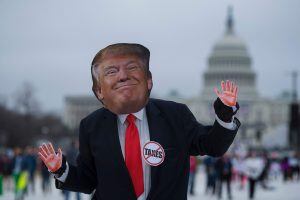 A demonstrator wearing a mask of US President Donald Trump dances as others march past the US Capitol during the Women's March in Washington, DC, January 21, 2017.
Hundreds of thousands of protesters spearheaded by women's rights groups demonstrated acros