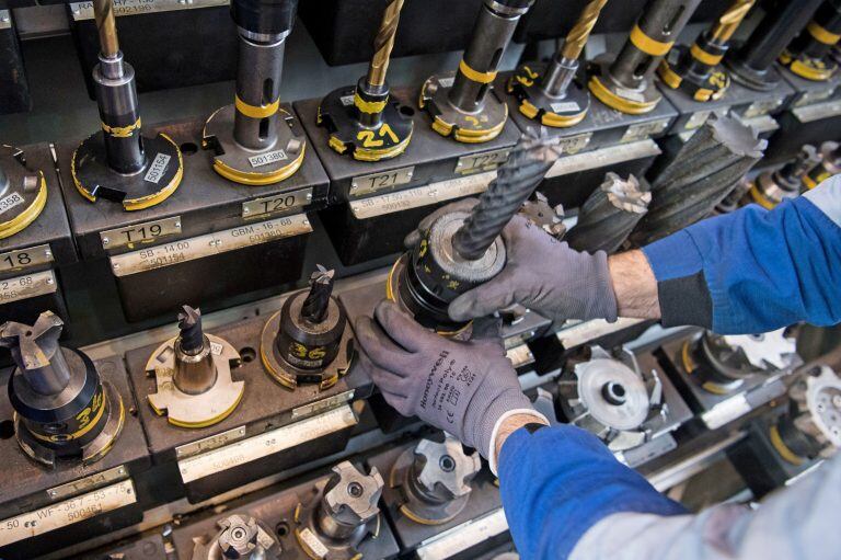 FILED - 03 March 2017, Baden-Wuerttemberg, Goeppingen: An employee of a machine builder takes drills from a shelf. Germany's machine manufacturing companies took another hit in August, with orders falling by 17 per cent compared to the same month last year, the Mechanical Engineering Industry Association (VDMA) said on Friday. Photo: Marijan Murat/dpa