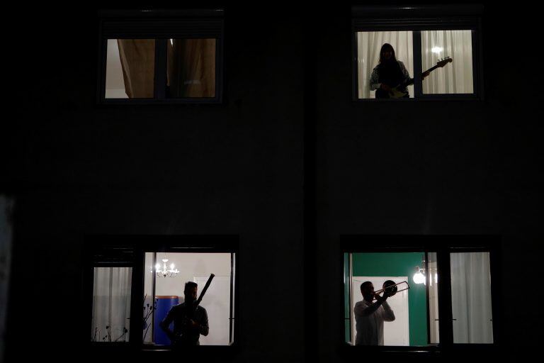 Belgrade (Serbia), 20/03/2020.- Residents play music from their windows during the curfew taking place from 8PM till 5AM in Belgrade, Serbia, 20 March 2020. The Serbian authorities declared the state of emergency on 15 March over the coronavirus situation. Several European countries have closed borders, schools and public facilities, and have cancelled major sports and entertainment events in order to prevent the spread of the coronavirus SARS-CoV-2 which causes the Covid-19 disease. (Belgrado) EFE/EPA/MARKO DJOKOVIC