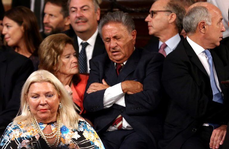 Lawmaker Elisa Carrio walks in front of the former Argentine President Eduardo Duhalde (C) and Argentina's Supreme Court President Ricardo Lorenzetti (R) and Supreme Court Judge Elena Highton de Nolasco as they attend the speech of Argentina's President Mauricio Macri at the opening session of the 136th legislative term at the Congress in Buenos Aires, Argentina, March 1, 2018. REUTERS/Marcos Brindicci