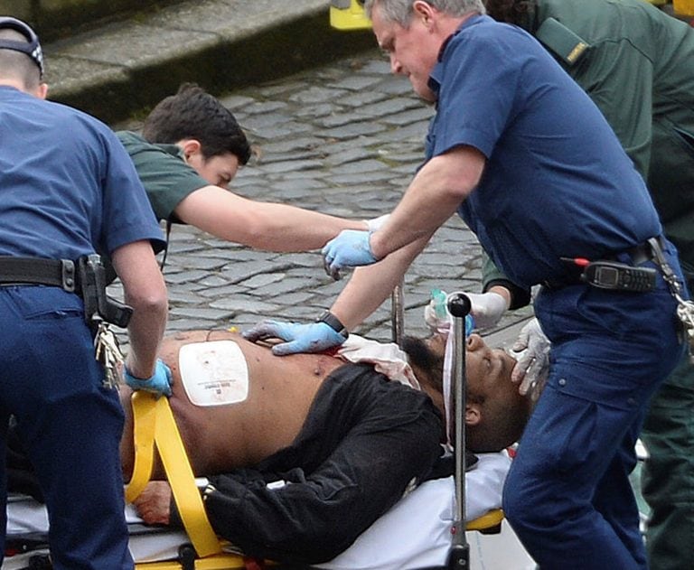 An attacker is treated by emergency services outside the Houses of Parliament London, Wednesday, March 22, 2017.  London police say they are treating a gun and knife incident at Britain's Parliament "as a terrorist incident until we know otherwise." The M