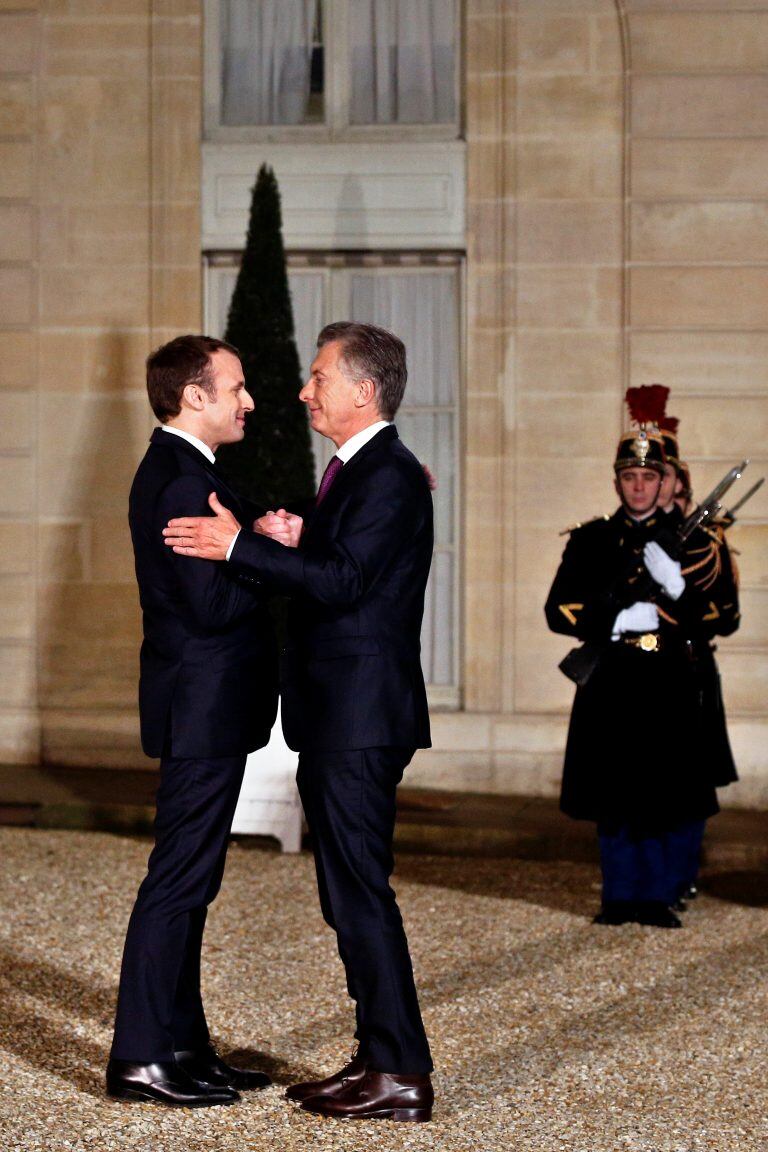 France President Emmanuel Macron, left, welcomes President of Argentina Mauricio Macri prior to a meeting, at the Elysee Palace, in Paris, Friday, Jan. 26, 2018. (AP Photo/Thibault Camus)