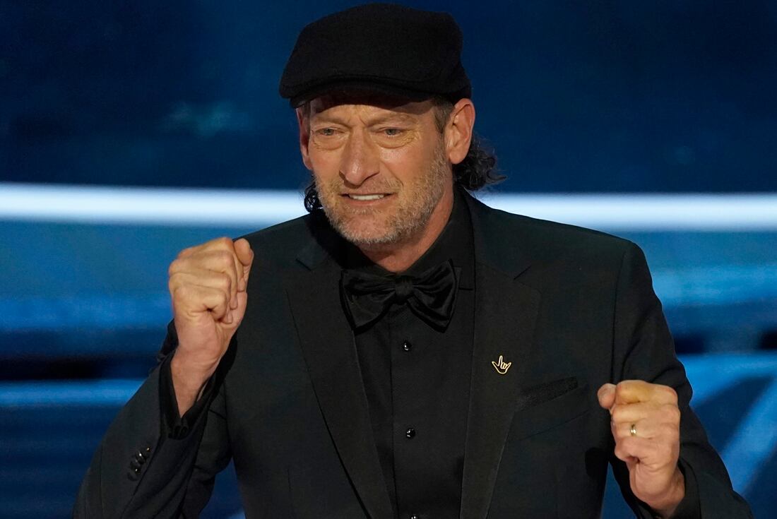 Troy Kotsur accepts the award for best performance by an actor in a supporting role for "CODA" at the Oscars on Sunday, March 27, 2022, at the Dolby Theatre in Los Angeles. (AP Photo/Chris Pizzello)