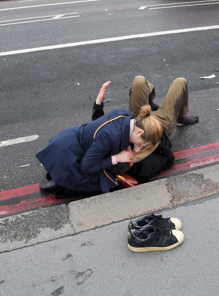 An injured person is assisted after an incident on Westminster Bridge in London, Britain March 22, 2017.  REUTERS/Toby Melville