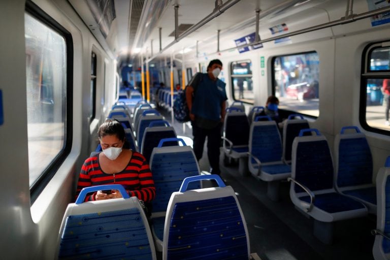 Passengers wearing face masks wait for their train to depart, at Constitucion railway station, as the spread of the coronavirus disease (COVID-19) continues, in Buenos Aires, Argentina April 16, 2020. REUTERS/Agustin Marcarian