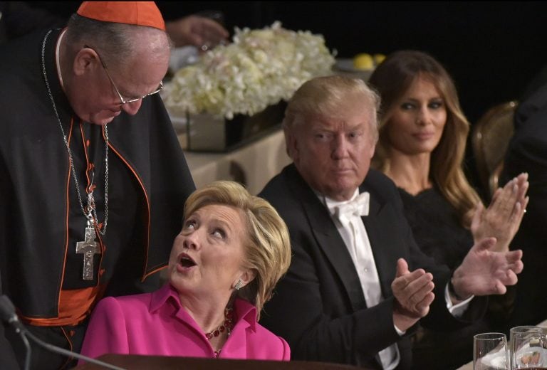 TOPSHOT - Democratic presidential nominee Hillary Clinton (2nd L) and Archbishop of New York Timothy Cardinal Dolan (L) chat watched by Republican presidential nominee Donald Trump and his wife Melania Trump during the 71st annual Alfred E. Smith Memorial