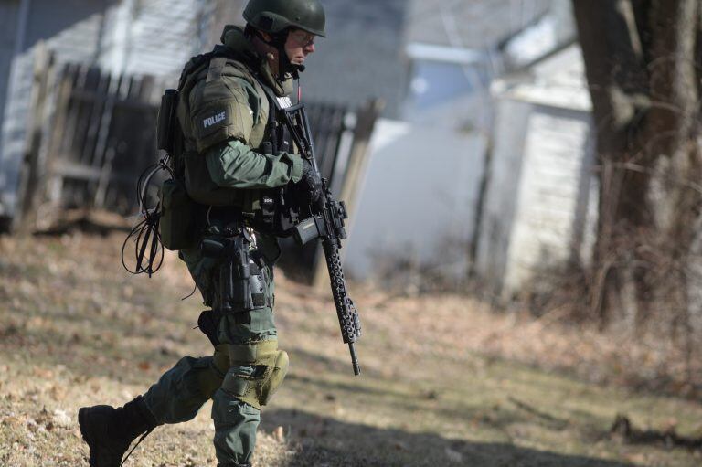 Police search neighborhoods near Central Michigan University for a 19-year-old student suspected of killing his parents at a dormitory and then running from campus, Friday, March 2, 2018 in Mount Pleasant, Mich. (Jacob Hamilton/The Bay City Times via AP)