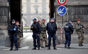 Police officers cordon off the area near the Louvre museum near where a soldier opened fire after he was attacked in Paris, Friday, Feb. 3, 2017. Police say the soldier opened fire outside the Louvre Museum after he was attacked by someone, and the area i