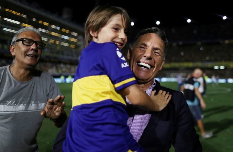 Soccer Football - Superliga - Boca Juniors v Gimnasia y Esgrima - Alberto J. Armando Stadium, Buenos Aires, Argentina - March 7, 2020   Boca Juniors coach Miguel Russo celebrates after winning the Superliga with his grandson   REUTERS/Agustin Marcarian