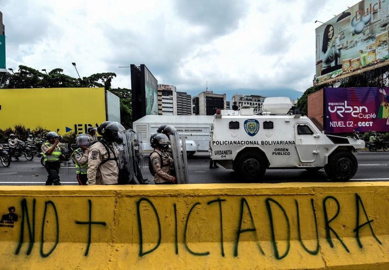 Riot police officers in position to crack down on demonstrators during a protest against Venezuelan President Nicolas Maduro, in Caracas on April 20, 2017. 
Venezuelan riot police fired tear gas Thursday at groups of protesters seeking to oust President N