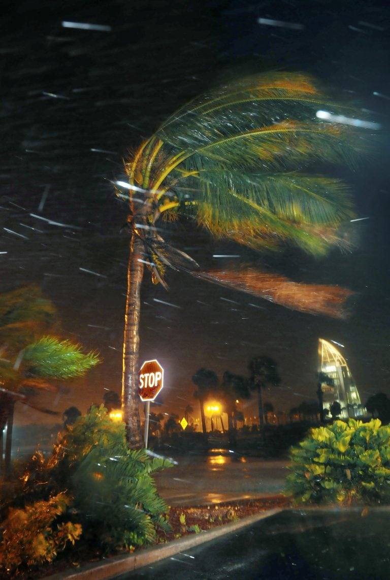 Trees sway from heavy rain and wind from Hurricane Matthew  in front of Exploration Tower early Friday, Oct. 7, 2016 in Cape Canaveral, Fla.   Matthew weakened slightly to a Category 3 storm with maximum sustained winds near 120 mph, but the U.S. National Hurricane Center says it's expected to remain a powerful hurricane as it moves closer to the coast.  (Craig Rubadoux/Florida Today via AP)