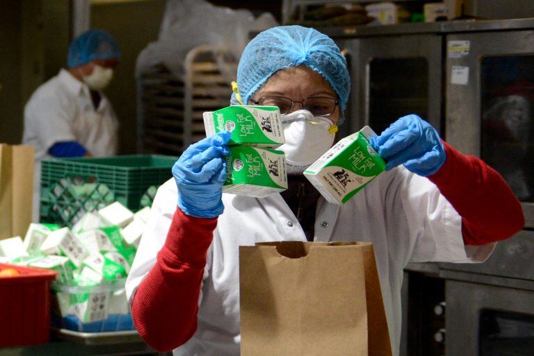 An employee of Meals on Wheels San Francisco, a nonprofit meal delivery service for homebound elderly and those with medical conditions, prepares meals for delivery to seniors during the coronavirus disease (COVID-19) crisis in San Francisco, California, U.S. March 20, 2020.  REUTERS/Kate Munsch