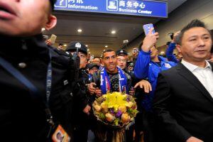 Argentine striker Carlos Tevez makes his way through the arrivals halls at Shanghai Pudong International Airport in Shanghai on January 19, 2017. 
Tevez arrived to a rousing welcome from hundreds of fans in Shanghai, where he will join local side Shenhua 