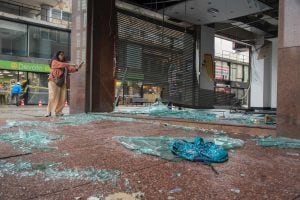 A woman takes a picture of a badly damaged business premise in front of Independencia square in Montevideo on January 3, 2017.
A severe thunderstorm with winds of more than 100 km an hour wreaked havoc in the Uruguayan capital, knocking down trees and dam