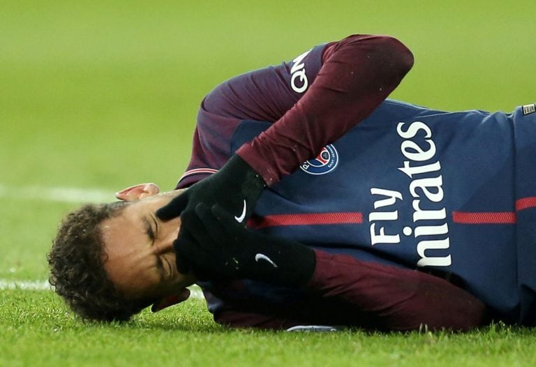 FILE PHOTO: Soccer Football - Ligue 1 - Paris St Germain vs Olympique de Marseille - Parc des Princes, Paris, France - February 25, 2018   Paris Saint-Germain’s Neymar lies on the pitch after sustaining an injury  Picture taken February 25, 2018.  REUTERS/Stephane Mahe/File Photo