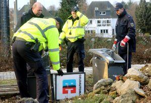 Police officers gather the remains of a cash machine at the railway station in Dinslaken, Germany, Thursday Jan. 12, 2017.  A freight train has partly derailed in Germany after hitting a stolen cash machine that had been left on the track. Police said no 