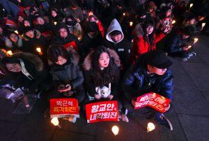 Protesters attend a candle-lit rally calling for South Korean President Park Geun-Hye's immediate departure from her office, in downtown Seoul on December 31, 2016.
South Korea sees in the new year with a massive protest calling for an immediate arrest of