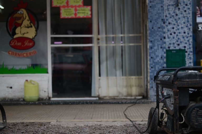 Dos vecinos de City Bell recorren las calles con un generador eléctrico para que los damnificados por el apagón puedan cargar el tanque de agua. (0221).