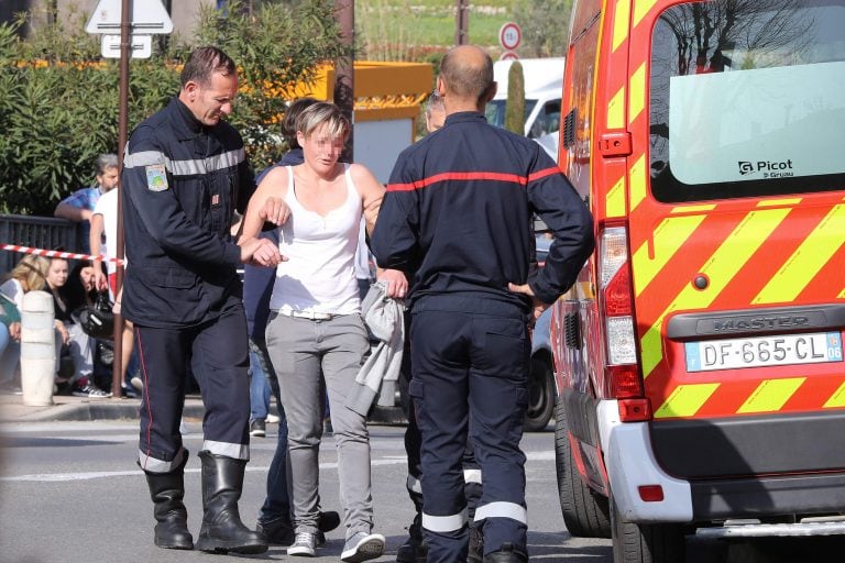 Firefighters help a person to walk toward a vehicle near the Tocqueville high school in the southern French town of Grasse, on March 16, 2017 following a shooting that left eight people injured.
At least eight people were injured in a shooting at a high s