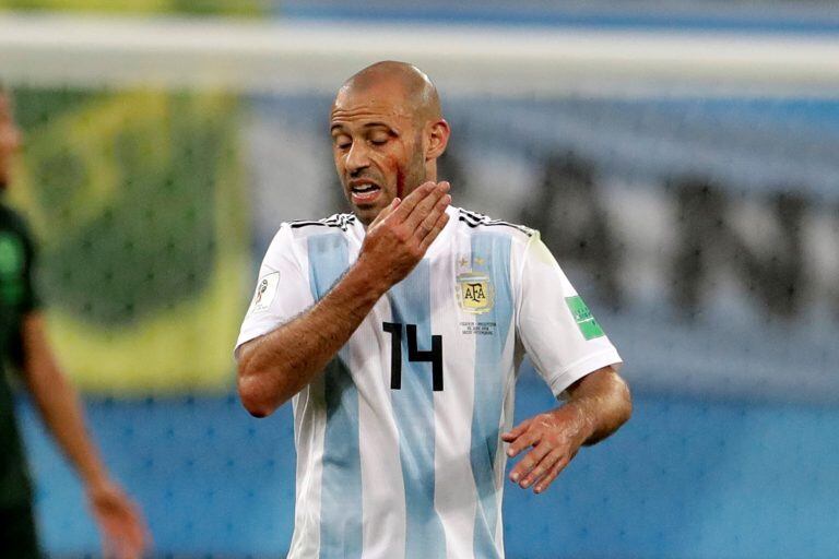 Argentina's Javier Mascherano touches his face after an injuring during the group D match between Argentina and Nigeria, at the 2018 soccer World Cup in the St. Petersburg Stadium in St. Petersburg, Russia, Tuesday, June 26, 2018. (AP Photo/Petr David Josek)