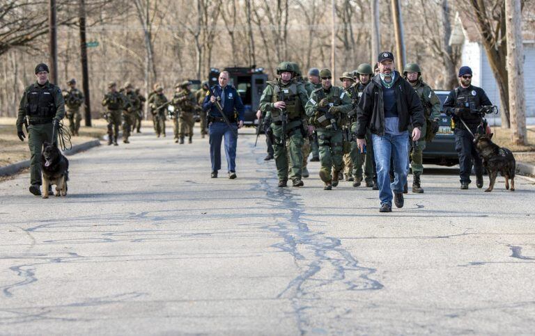 Police search for 19-year-old suspect James Eric Davis Jr. in local neighborhoods after a fatal shooting at Central Michigan University's Campbell Hall, on Friday, March 2, 2018, in Mount Pleasant, Mich. Davis is a sophomore at the school. (Cory Morse/The Grand Rapids Press-MLive.com via AP)