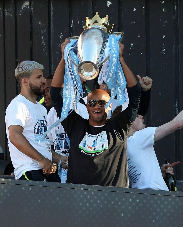 Manchester City's Vincent Kompany lifts the Premier League trophy during the trophy parade in Manchester, England, Monday May 20, 2019, after winning the English FA Cup. Victory for Pep Guardiola’s side came a week after the English Premier League trophy was retained to join the League Cup and Community Shield already in City’s possession. (Nick Potts/PA via AP)