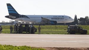 Maltese troops survey a hijacked Libyan Afriqiyah Airways Airbus A320 on the runway at Malta Airport, December 23, 2016. REUTERS/Darrin Zamit-Lupi   MALTA OUT