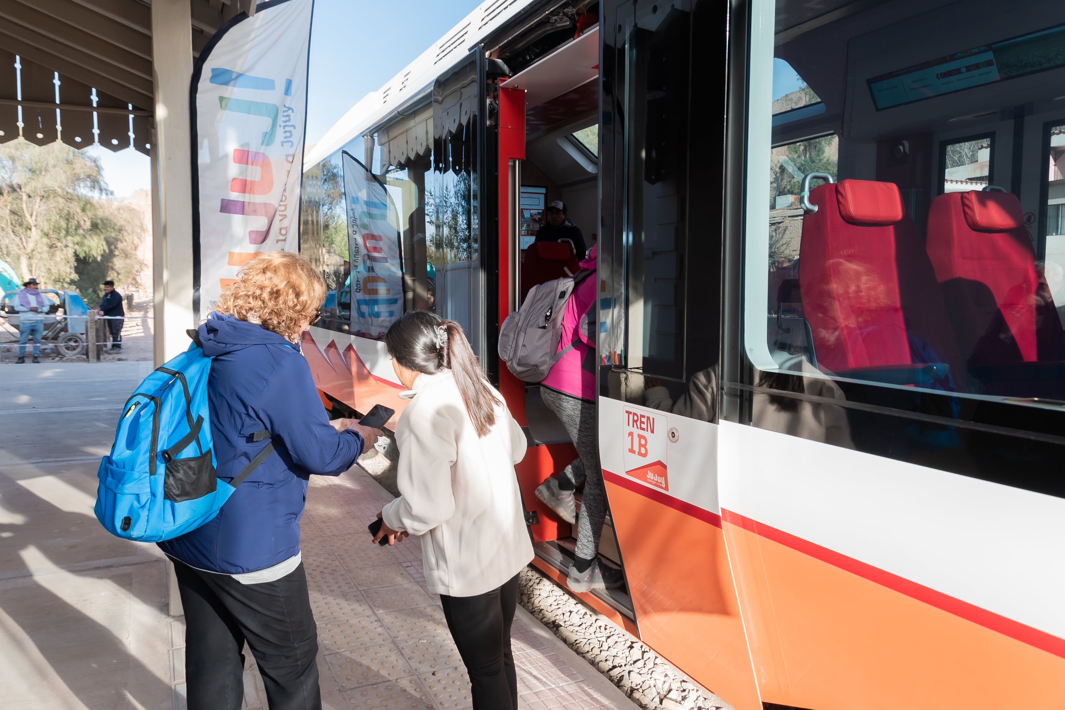 Una de las primeras turistas que aborda el viaje inaugural del Tren Solar desde Tilcara, recibe información acerca de la experiencia.