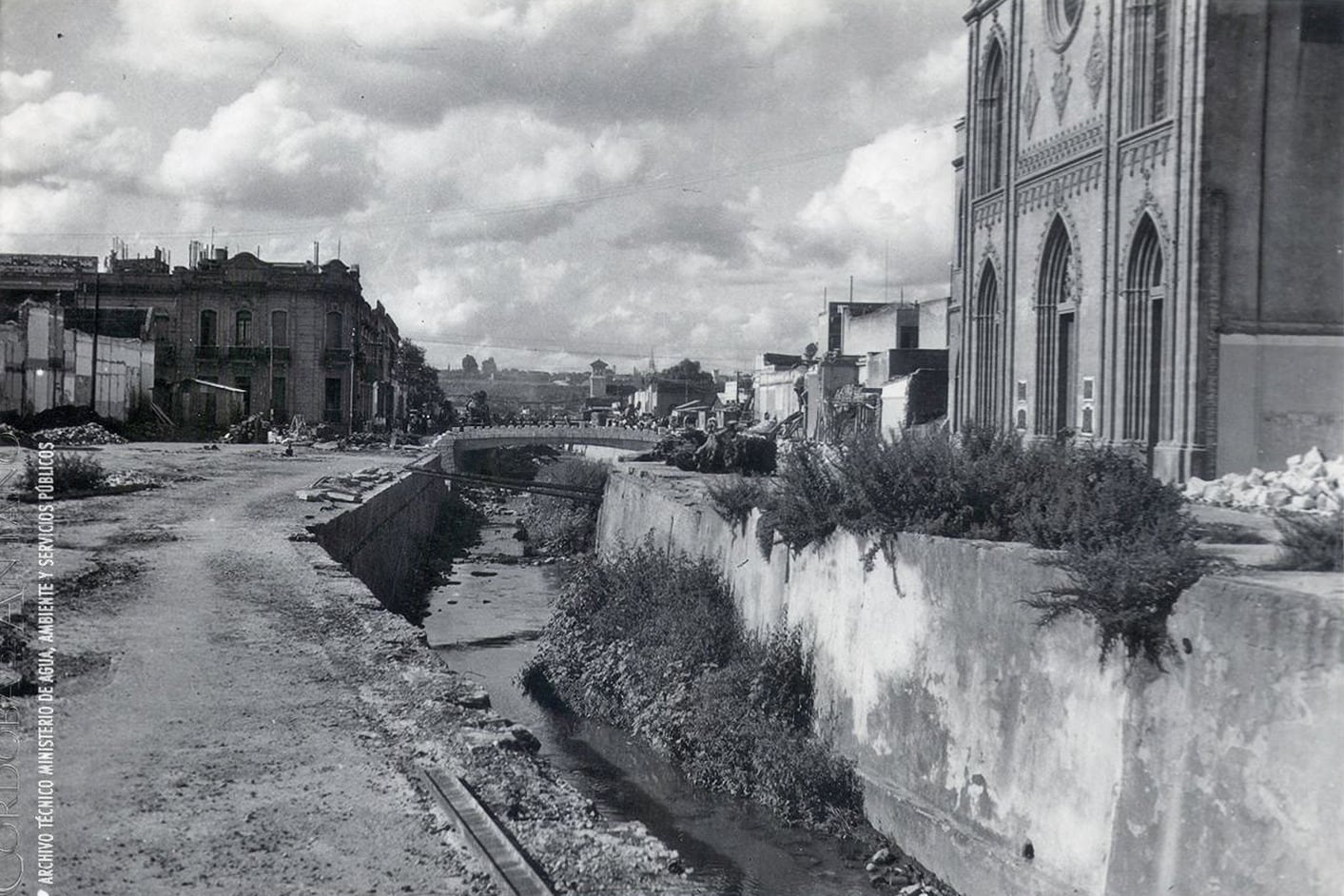 Una vista hacia el norte del viejo cauce de la Cañada. Al centro, el puente de Av. Colón y a la derecha, la iglesia Nuestra Señora del Carmen. La foto es del año 1946.
