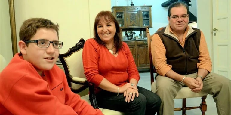 Nicolás Flores, junto a sus padres Sandra Violino y Osvaldo Flores en su casa en Córdoba. Archivo La Nación