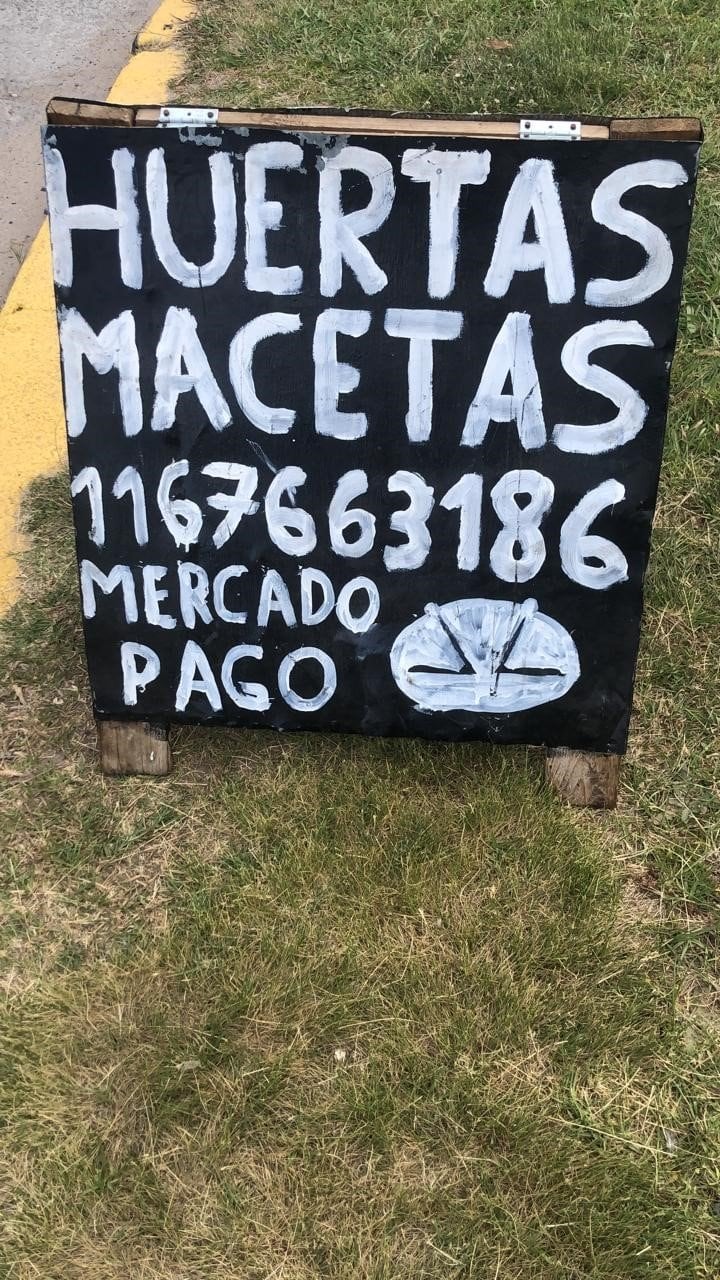 Vendedor de macetas arma a mano un cartel de Mercadopago