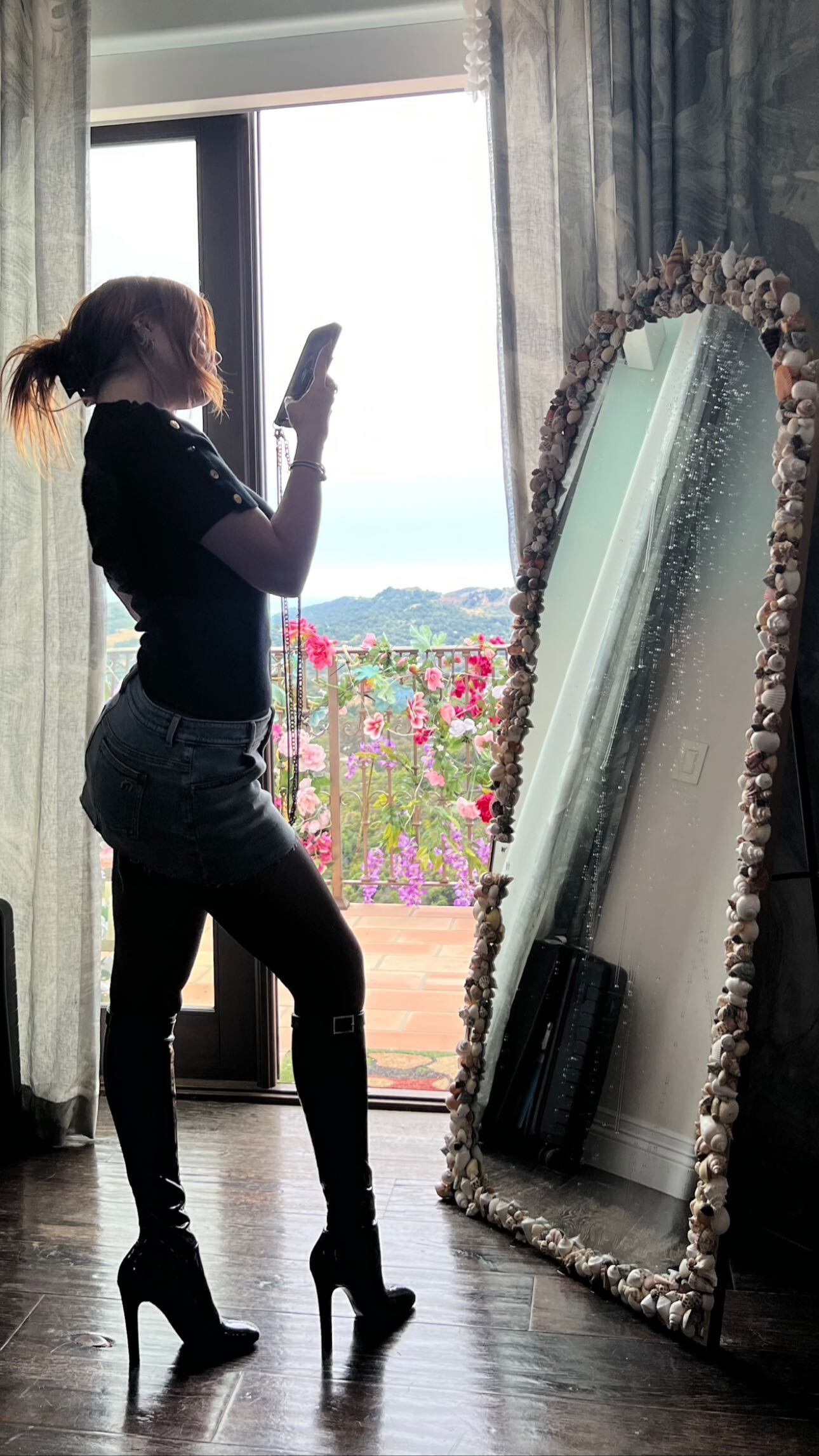 Casi a oscuras, Bella Thorne posó con una minifalda de jean, bucaneras, top y pantimedias.