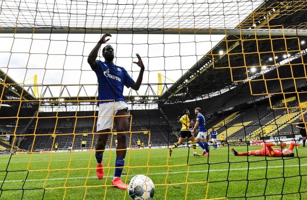Soccer Football - Bundesliga - Borussia Dortmund v Schalke 04 - Signal Iduna Park, Dortmund, Germany - May 16, 2020 Schalke's Salif Sane reacts in the goal after Dortmund's Raphael Guerreiro scored his side's second goal against Schalke's goalkeeper Markus Schubert, right, as play resumes behind closed doors following the outbreak of the coronavirus disease (COVID-19) Martin Meissner/Pool via REUTERS  DFL regulations prohibit any use of photographs as image sequences and/or quasi-video
