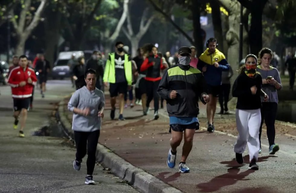 People jog at a park, as the city of Buenos Aires eases their lockdown restrictions, during the spread of the coronavirus disease (COVID-19), in Buenos Aires, Argentina June 8, 2020. REUTERS/Agustin Marcarian