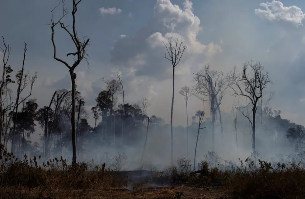 An area smolders in the Alvorada da Amazonia region in Novo Progresso, Para state, Brazil, Sunday, Aug. 25, 2019. (AP Photo/Leo Correa)