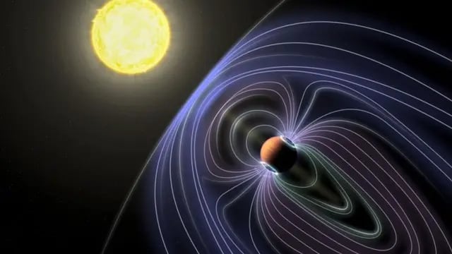 En esta representación artística del sistema Tau Boötes b, las líneas que representan el campo magnético invisible se muestran protegiendo al planeta Júpiter caliente del viento solar