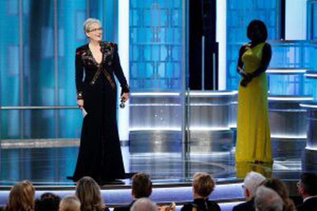 This image released by NBC shows Meryl Streep accepting the Cecil B. DeMille Award as presenter Viola Davis, right, looks on, at the 74th Annual Golden Globe Awards at the Beverly Hilton Hotel in Beverly Hills, Calif., on Sunday, Jan. 8, 2017. (Paul Drink