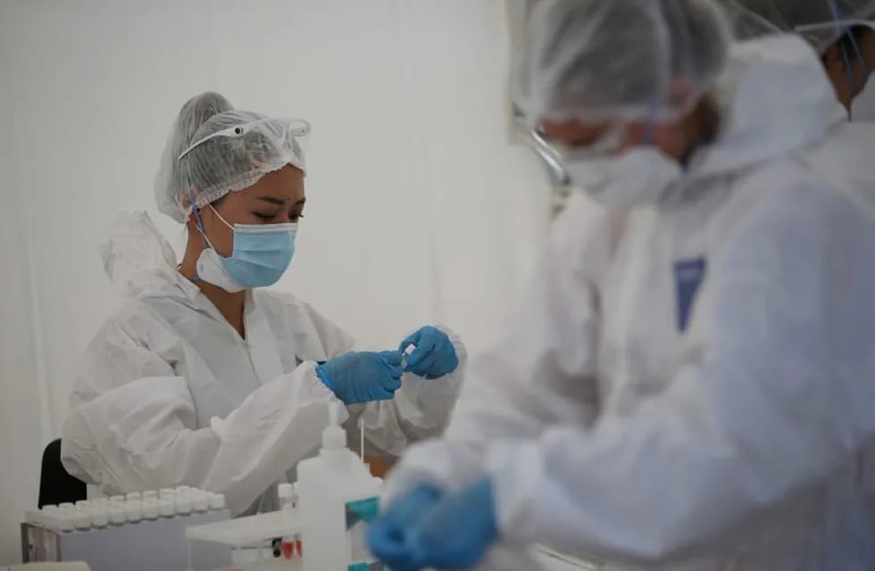 Health workers are seen at a mobile testing station for the coronavirus disease (COVID-19) in Almaty, Kazakhstan June 17, 2020. REUTERS/Pavel Mikheyev