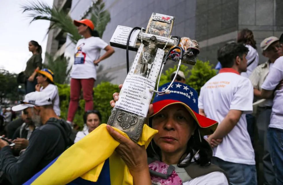 Opposition supporters demonstrate outside the headquarters of the United Nations Development Programme during the visit of the UN High Commissioner for Human Rights Michelle Bachelet, in Caracas on June 21, 2019. - Bachelet arrived in Venezuela Wednesday as part of a visit to review the country's ongoing economic and political crisis. (Photo by CRISTIAN HERNANDEZ / AFP)