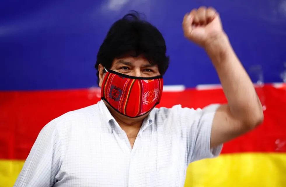 Former Bolivian President Evo Morales raises his fist as he arrives for a press conference at Movement Towards Socialism (MAS) headquarters in Buenos Aires, Argentina, during general elections in his home country, Sunday, Oct. 18. 2020. (AP Photo/Marcos Brindicci)